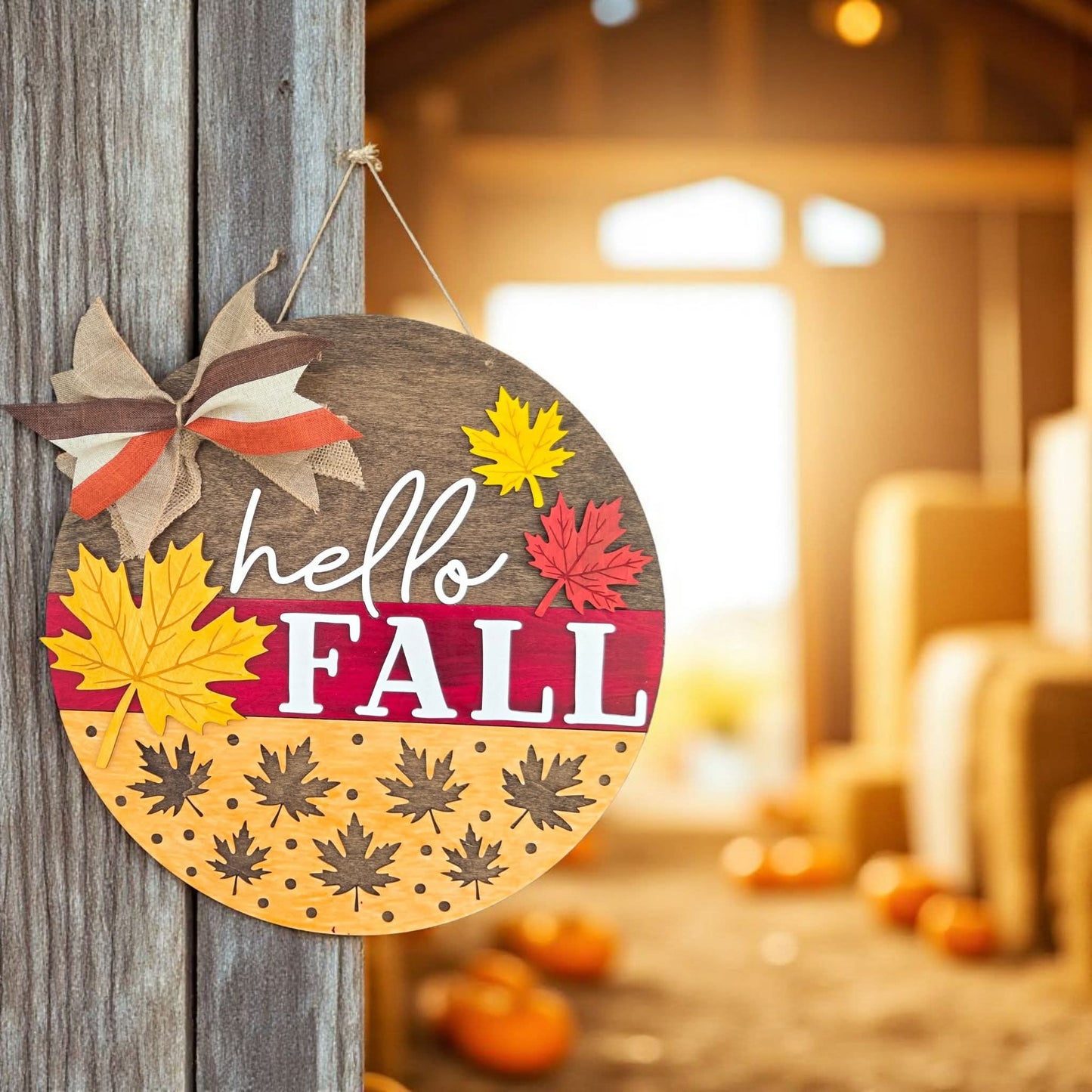Decorative sign with 'hello FALL' text and autumn leaves on a wooden door.