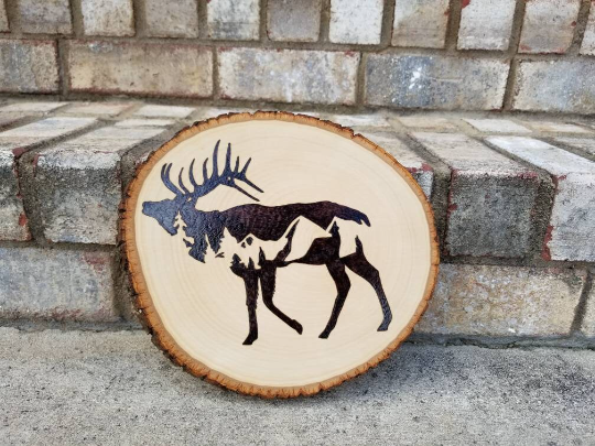 Elk silhouette with mountain scene